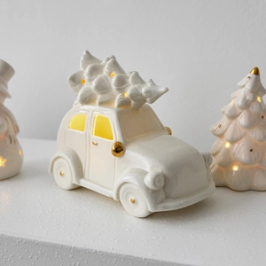 Ceramic vintage white car with Christmas tree and warm glowing lights holiday decor