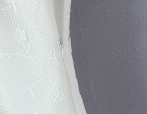 Detailed close-up showing white floral lace embroidery and a side invisible zipper