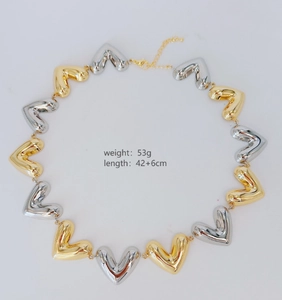 Flat lay of gold and silver heart necklace showing 42+6cm length and 53g weight specs