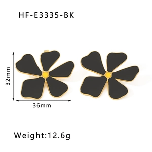 Detail view of black flower earrings with gold edges including 32x36mm size specifications