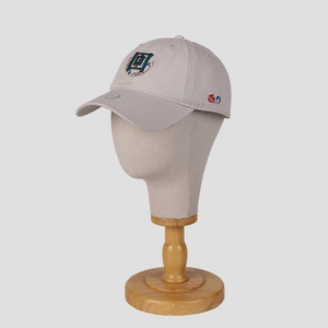 Classic beige baseball cap with Chinese style embroidery on a minimalist mannequin
