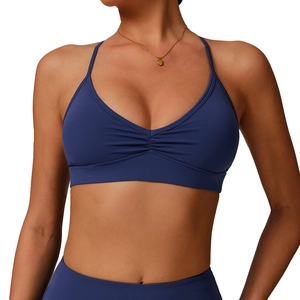Navy blue V-neck sports bra with ruched detail and cross back straps for yoga and fitness
