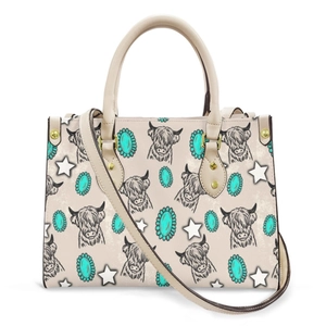 Detail of Highland Cow print and turquoise accents on minimalist cream faux leather tote bag