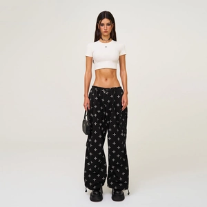 Women's streetwear set featuring white crop T-shirt and black floral pattern wide-leg pants
