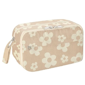Detail of corduroy pencil case with white floral pattern and double zipper closure