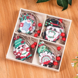 Set of 4 handcrafted wooden Christmas gnomes with rustic twine and red beads in a box