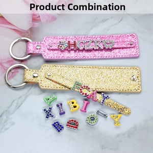 DIY glitter 8mm sequin keychains with assorted rhinestone letters on marble background