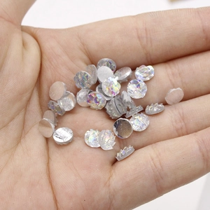 Macro shot of 6mm resin fish scale flatback cabochons with AB rainbow finish for DIY