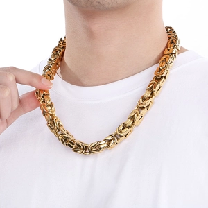 Close-up of a gold chunky Byzantine chain necklace made of stainless steel on a model