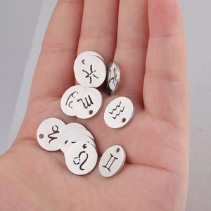 Detailed close-up of 12mm stainless steel zodiac pendants with hollow horoscope symbols