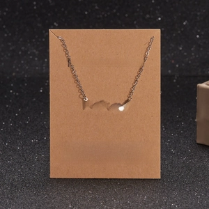 Silver stainless steel Mama necklace on a Make a Wish message card with heart detail