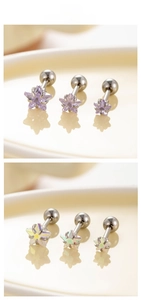 Detailed view of star-shaped titanium steel ear studs with colorful zircon and screw backs