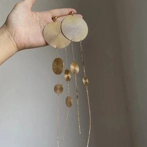 Exaggerated gold geometric fringe earrings with concentric spiral texture discs