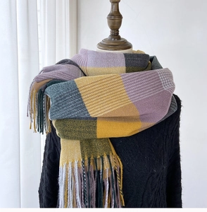 Detail of checkered cashmere-feel scarf with fringes in yellow and purple tones