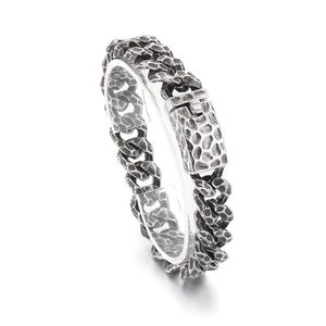 Men's hammered titanium steel Cuban chain bracelet with vintage silver finish on white stand