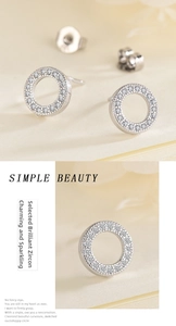 Macro shot of silver stud earrings featuring hollow circle design and sparkling pavé zircons