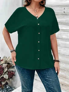 Detail of dark green V-neck blouse with front buttons and breathable texture on model