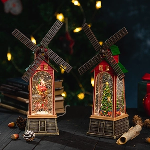 Vintage Christmas windmill lantern with Santa Claus and tree inside, warm glowing light