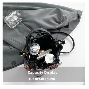 Interior view of floral embroidered black bucket bag showing spacious storage capacity