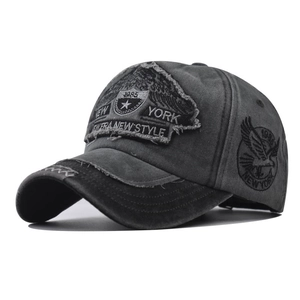 Detailed close-up of distressed vintage New York embroidery and eagle patch on cotton cap