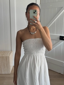 White cotton strapless smocked maxi dress with a flowy A-line silhouette for summer
