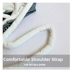 Detail of soft white padded nylon strap with plush down-like texture on crossbody bag