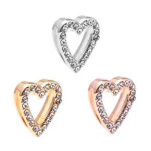 Three hollow heart pendants in silver, gold, and rose gold with sparkling rhinestones