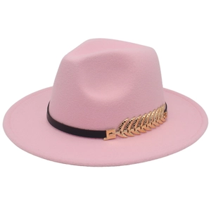 Close-up of pink wool fedora hat featuring black band and golden metal leaf detail