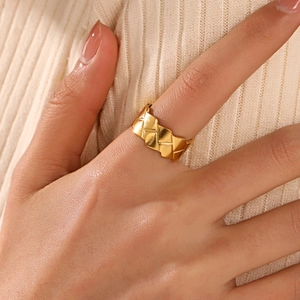 Minimalist 18k gold plated geometric ring with quilted pattern on a model hand