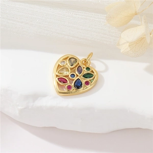 Golden heart pendant with colorful zircon stones on white aesthetic background