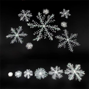 White plastic snowflake Christmas ornaments in various sizes with a reflective finish