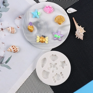 Macro detail of white silicone mold for seashell starfish and crab fondant shapes