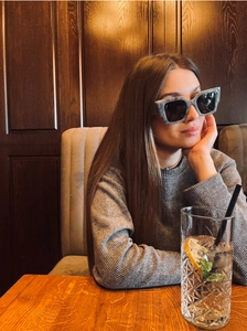 Chic grey marble square sunglasses on a female model in a vintage cafe setting
