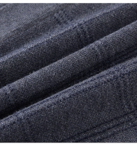 Close-up of charcoal gray knit fabric showing the soft wool blend texture and weave detail