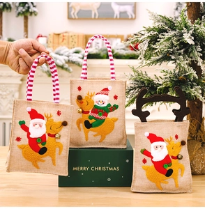 Close-up of burlap Christmas gift bags with 3D Santa and Reindeer embroidery designs