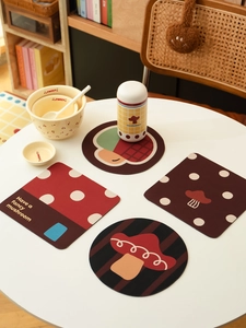 Detailed view of mushroom pattern absorbent coasters on a dining table with warm home decor