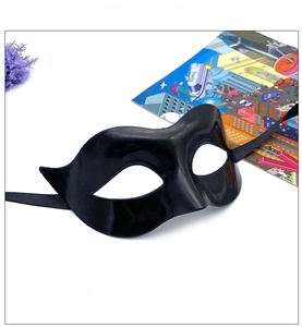 Detail of black half-face masquerade mask with glossy finish and ribbon ties