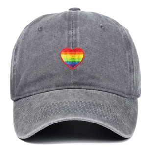 Detail shot of rainbow heart embroidery on dark grey washed cotton baseball cap texture