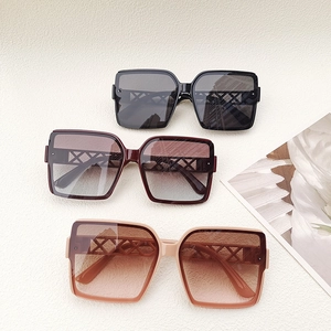 Three pairs of oversized square sunglasses with cutout temples in black, red and pink