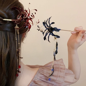 Detail of red and blue Lycoris radiata hairpins with long tassels in a traditional style