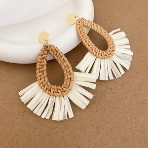 Bohemian woven drop earrings with raffia tassels and natural rattan details for beach