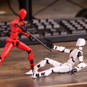 3D printed multi-jointed action figure set in red and white colors on a desk