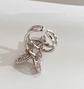 Close-up of double butterfly silver ring with zircon stones and hollow structure