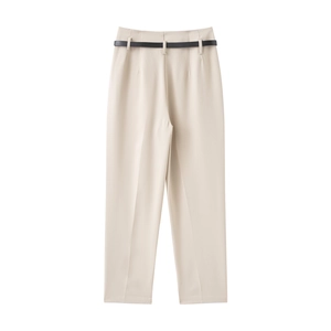 Detail view of high-waist beige trousers with smooth fabric texture and slim black belt