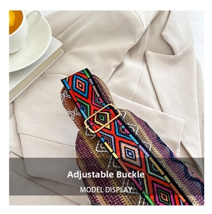 Detail of colorful ethnic woven strap with golden adjustable metal buckle on bag