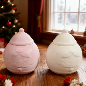 Christmas Santa Claus ceramic storage jars in pink and white with embossed lid decoration