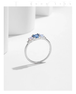 Macro shot of S925 sterling silver ring featuring oval blue stone and side engraving