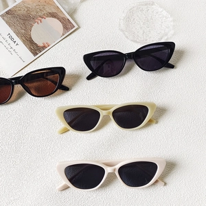 Retro cat-eye sunglasses for women in black, brown, and cream colors on a white background