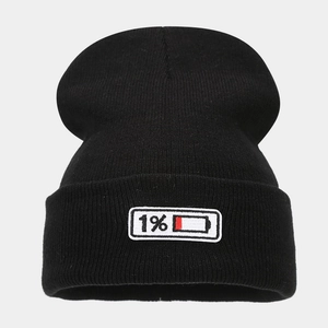 Close-up of black ribbed knit beanie featuring 1% battery percentage embroidery patch