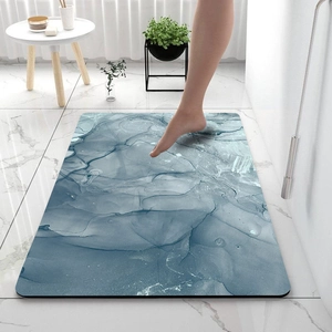 Detail of blue marble diatom mud bath mat with non-slip texture in modern bathroom décor